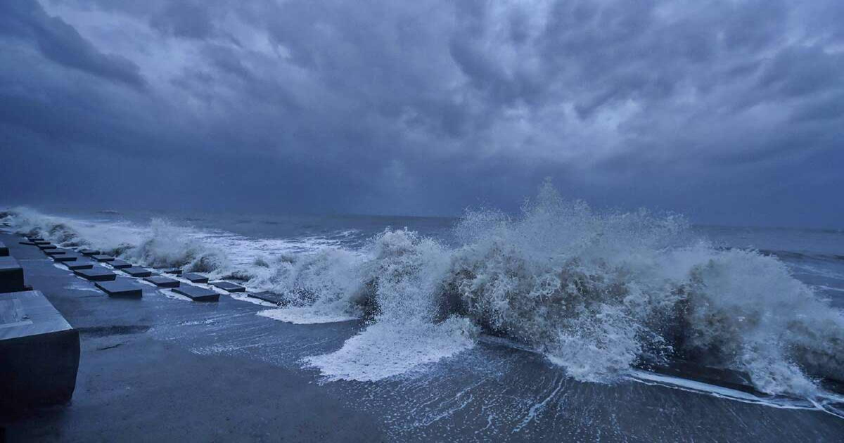 A powerful cyclone over the Bay of Bengal off India's eastern coastline, with dark swirling clouds and rough seas